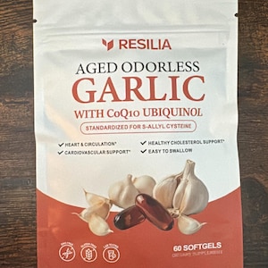 May include: A white and reddish-brown pouch of Resilia Aged Odorless Garlic with CoQ10 Ubiquinol dietary supplement. The front features text, garlic bulb illustrations, two dark softgels, and icons for GMO-free, gluten-free, and lab-tested, with 60 softgels.