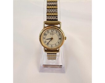 Reloj Seiko Quartz 3E22-0069 para mujer, tono dorado, correa bicolor extensible, esfera con fecha.