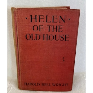 May include: A vintage hardcover book titled "HELEN OF THE OLD HOUSE" by Harold Bell Wright. The book has a red cover with black lettering. The book is standing upright, showing the spine and front cover.