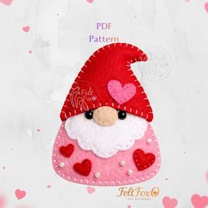 May include: A felt gnome with a red hat and pink body, decorated with red hearts and white pearls. The gnome has a white beard and a beige nose. The image includes the text "PDF Pattern".