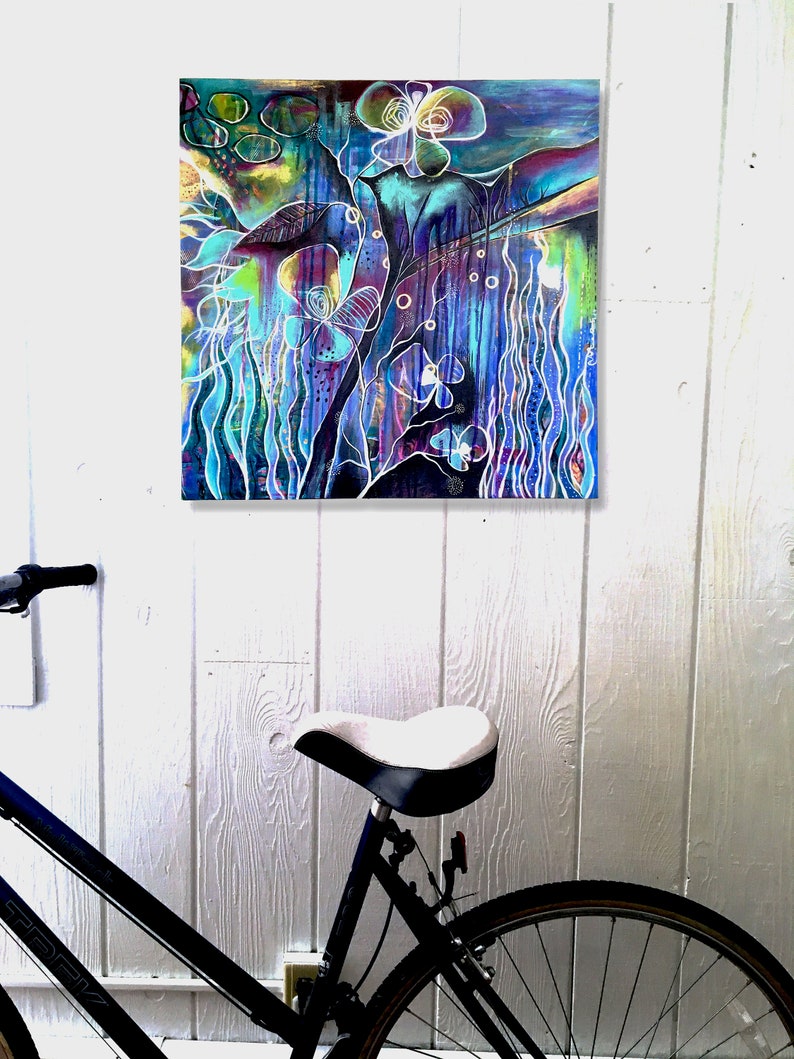 May include: Abstract painting with a blue, purple, and green color scheme. The painting features a variety of shapes and lines, including flowers, butterflies, and swirls. The painting is framed and hanging on a white wall.