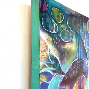 May include: Abstract painting on canvas with a teal, green, purple, and gold color scheme. The painting features a variety of shapes and textures, including circles, lines, and dots.