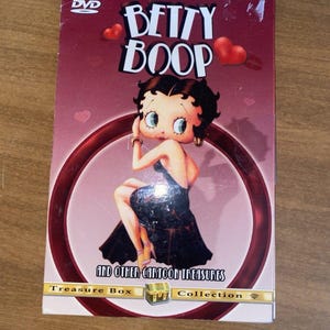 May include: A DVD case featuring Betty Boop, with the words "Betty Boop" in large, white letters. The case has a burgundy background with a circular design and the text "And Other Cartoon Treasures". The DVD is digitally remastered.