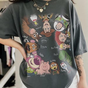 Retro cartoon characters with names in a colorful design on a casual t-shirt.