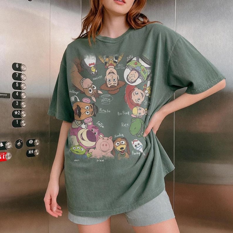 Cartoon characters from Toy Story in a retro style with names, on a green t-shirt.