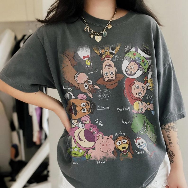 Retro cartoon characters with names in a colorful design on a casual t-shirt.