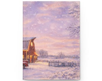 May include: A journal featuring a winter landscape with a red barn, a red truck, and a snow-covered field. The sky is a soft pink and purple, with falling snow. The barn has lit windows, suggesting warmth.
