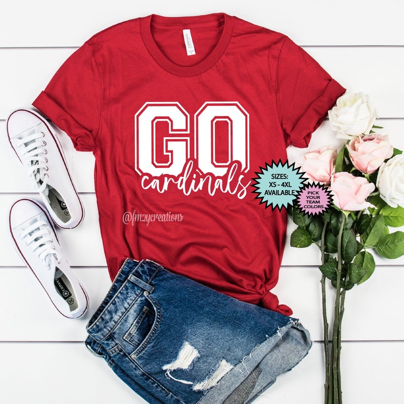 May include: Red t-shirt with white text that says "GO cardinals" in a collegiate font. The shirt is available in sizes XS-4XL and you can pick your team colours.