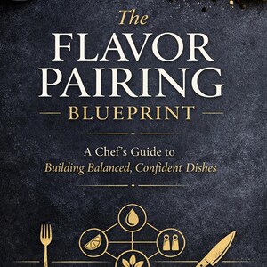 May include: A cookbook cover with the title "The Flavor Pairing Blueprint" and the subtitle "A Chef's Guide to Building Balanced, Confident Dishes." The image features ingredients like tomatoes, rosemary, and lemon, along with a fork and knife.