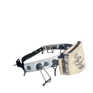 May include: A white tool belt with metal hardware and a small canvas pouch. The pouch has the text "Klein Tools" and "5116T" printed on it. The belt has a black strap and various metal loops and hooks.