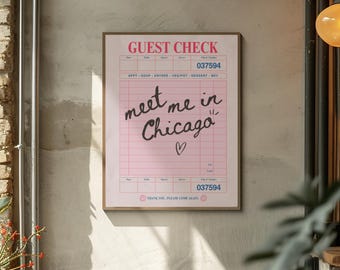 May include: A framed pink guest check print with the words "meet me in Chicago" in black script. The print has a vintage aesthetic, with a heart symbol and the check number 037594.