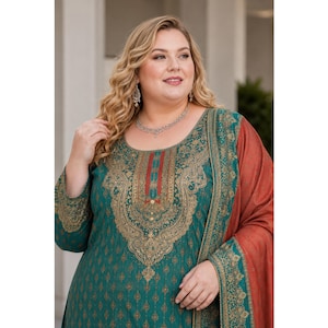 May include: A teal long-sleeved tunic featuring an intricate gold-toned paisley and floral pattern across the chest and sleeves, paired with a solid rust-colored shawl draped over one shoulder, showcasing a round neckline and detailed embroidery.