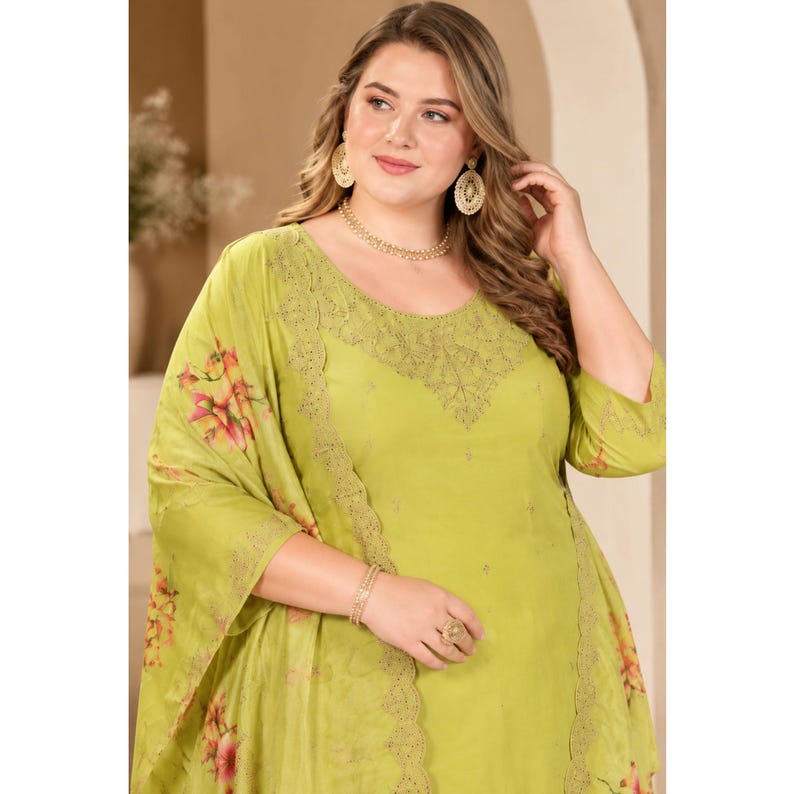 May include: A lime green tunic featuring a round neckline with intricate embroidery, three-quarter length sleeves, and a matching shawl draped over one shoulder. The shawl displays a vibrant floral print in shades of pink, orange, and green.