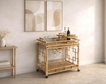 May include: A two-tiered bamboo bar cart on wheels featuring a slatted design, a built-in rack for hanging stemware, and a removable top tray. The cart holds two wine bottles and two clear glass wine glasses on its upper surface.