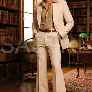 May include: A cream-colored suit with a flared leg, paired with a patterned button-down shirt and brown leather belt. The man is wearing brown leather shoes. The background includes bookshelves, globes, and a desk, suggesting a vintage or retro theme.