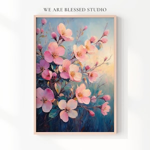 Puede incluir: Una impresión artística enmarcada que muestra una pintura de flores rosas sobre un fondo azul y amarillo. La obra de arte presenta un primer plano de delicadas flores y capullos en ramas, con el texto "WE ARE BLESSED STUDIO" en la parte superior.