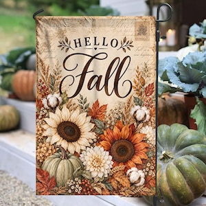 May include: A rectangular garden flag featuring the text "HELLO Fall" in black script and serif fonts. The design includes a vintage paper background with postal stamps, surrounded by illustrations of sunflowers, pumpkins, and cotton.