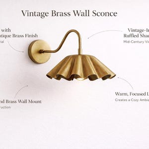 Pair of vintage brass wall sconces with downward, ruffled shades and curved arms, antique brass finish.