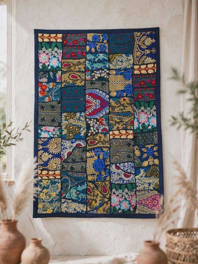 May include: A rectangular wall hanging featuring a patchwork design of various fabric squares. The textile displays a vibrant array of colors including deep blue, gold, red, and green, with intricate embroidery, sequins, and floral patterns.