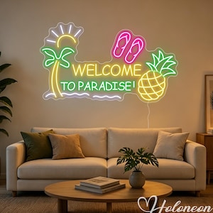 May include: A neon sign featuring the text WELCOME TO PARADISE in yellow and green. The design includes a yellow sun, a green palm tree, pink flip-flops, and a yellow pineapple. The sign is mounted on a wall above a beige sofa and coffee table.