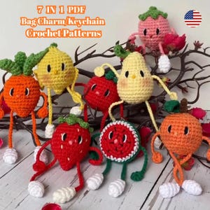 May include: A selection of seven crocheted fruit-shaped bag charms or keychains. The charms include a carrot, lemon, strawberry, pear, watermelon, and orange, each with arms, legs, and smiling faces. The text "7 IN 1 PDF Bag Charm/Keychain Crochet Patterns" is visible.