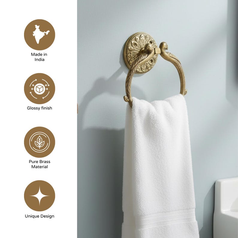 May include: A brass towel ring with a decorative floral design and a glossy finish. The ring is holding a white towel. The text on the image says "Made in India", "Glossy finish", "Pure Brass Material", and "Unique Design".