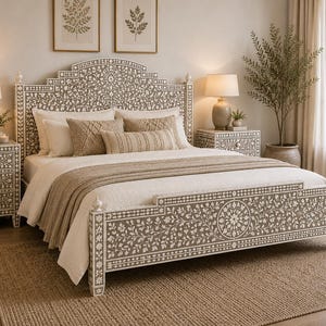 May include: A bed frame and matching bedside tables featuring an intricate white floral inlay pattern set against a taupe background. The headboard and footboard display detailed botanical motifs, complemented by white bedding and textured throw pillows.