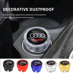 May include: A clear, decorative dustproof car accessory with the Audi logo in white and red. The text "DECORATIVE DUSTPROOF" is at the top. Additional accessories in black, red, blue, silver, and gold are shown below.