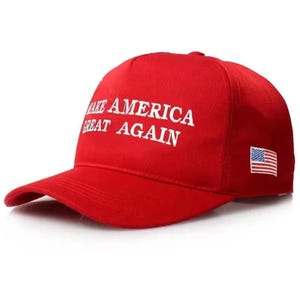 May include: A red baseball cap with the text "MAKE AMERICA GREAT AGAIN" in white block letters. The cap features a curved brim and an American flag patch on the side. The hat is a classic six-panel design.