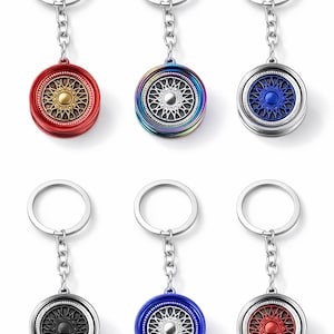 May include: A white ceramic mug with a black handle and the text "But First, Coffee" in a bold, black font. The mug is set against a blurred background, suggesting a cozy setting.