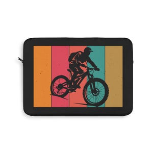 May include: Black laptop sleeve featuring a retro design of a mountain biker. The graphic is a silhouette in black against a backdrop of vertical stripes in orange, pink, teal, and tan. The sleeve has a black zipper.
