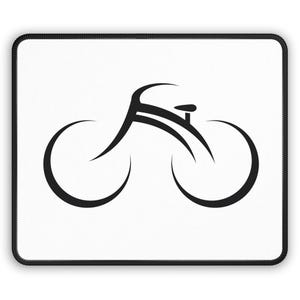 May include: A black and white mousepad featuring a minimalist bicycle design. The bicycle is depicted with curved lines, forming the wheels, frame, and seat. The mousepad has a white surface with a black stitched border.