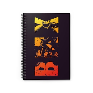 May include: Black spiral-bound notebook with a BMX design. The design features the word "BMX" vertically, with a silhouette of a cyclist and a helmeted rider in yellow and orange tones.