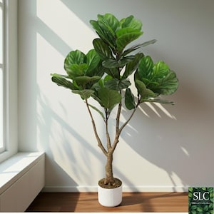 May include: A large artificial Fiddle Leaf Fig tree with vibrant green leaves and a textured brown trunk. The tree is potted in a white, textured pot. The image is well-lit, showcasing the plant's details. The tree is positioned near a window.