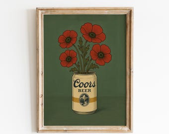 May include: A framed art print featuring a vintage-style illustration. A bouquet of red poppies sits in a Coors Beer can against a dark green background. The can has the Coors Beer logo and a mountain scene.