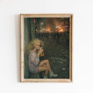 May include: A framed print shows a doll with a beer, sitting on a kerb with a chaotic street scene behind. The text "EVERYTHING IS FINE" is displayed. The print has a vintage aesthetic.