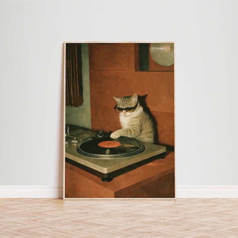 May include: A framed print featuring a tabby cat wearing sunglasses, operating a vintage turntable. The cat is positioned in front of a red-brown background. The turntable has a black vinyl record with an orange center.