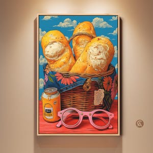 May include: A framed art print depicts a picnic scene. Three loaves of bread are in a wicker basket with a floral cloth. A jar and pink glasses sit on a red surface against a blue sky background.