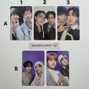 May include: A collection of six photo cards featuring various male subjects in different poses. The cards are arranged in two rows of three, labeled with numbers and letters. The text "Zerafinya_Merch" is visible.