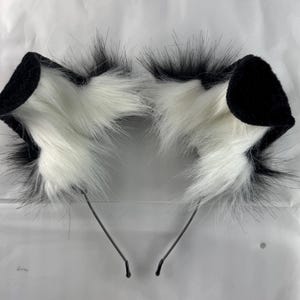 May include: A set of three ceramic mugs with a speckled, matte finish in cream, light grey, and dark grey. Each mug has a simple, modern design and a rounded handle.