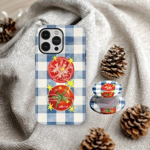 May include: A phone case and phone grip with a blue and white gingham pattern. The case features two tomato illustrations with the words "Love You" and "tomato world". The phone grip has a matching design.