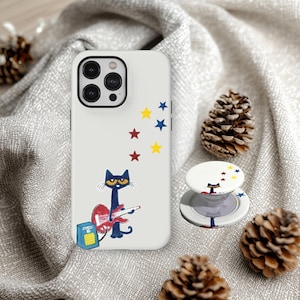 May include: White phone case with a black cat playing a red guitar, surrounded by yellow, red, and blue stars. A matching pop socket is also visible. The phone case and pop socket feature a cartoon cat design.