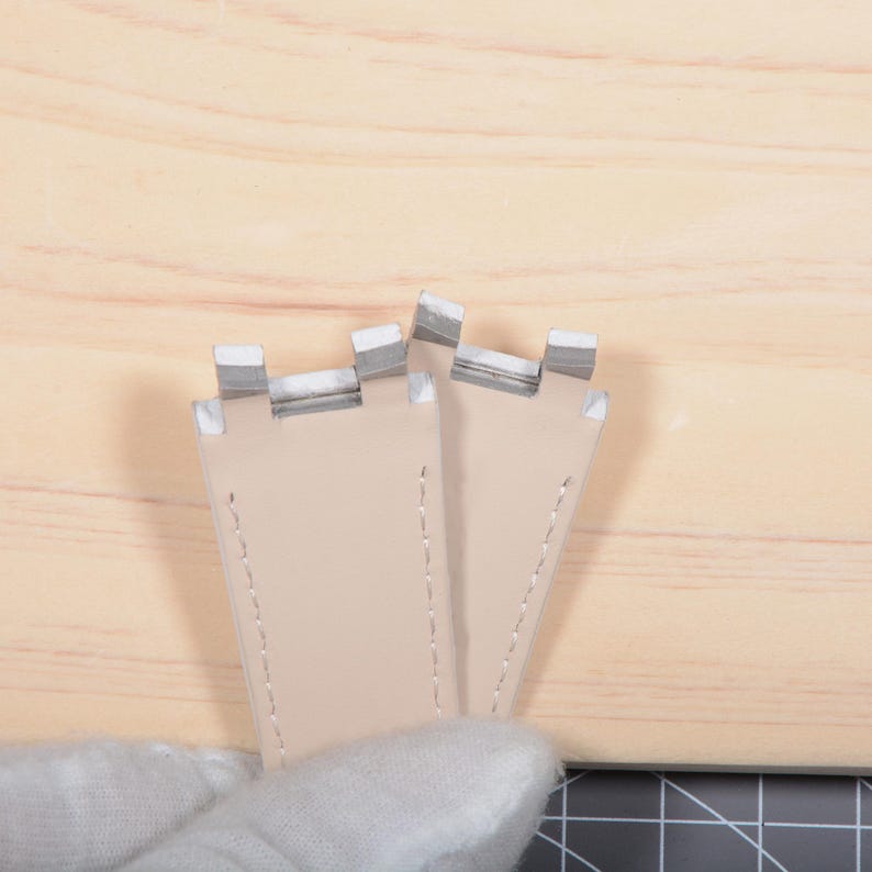 May include: A handmade, wooden cutting board with a natural finish. The board features a live edge, showcasing the wood's unique grain and shape. It is approximately 18 inches long and 12 inches wide.