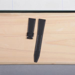 May include: A rustic wooden sign with the text "Welcome to our home" in white lettering. The sign features a distressed finish and a simple, inviting design, perfect for front door decor.