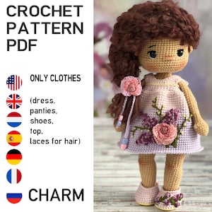 May include: A crocheted doll wearing a pink dress with floral embroidery, matching shoes, and a flower hair accessory. The doll has brown hair and is standing. Text on the left reads "CROCHET PATTERN PDF" and "ONLY CLOTHES".