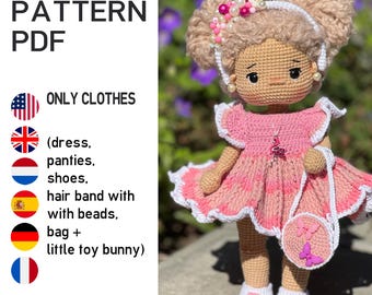 May include: A crocheted doll wearing a pink dress with white trim, a matching purse, and white shoes. The doll has blonde hair styled in two buns, adorned with a beaded headband. The image includes text that says "CROCHET PATTERN PDF" and "ONLY CLOTHES".