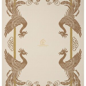 May include: Cream-coloured textile featuring a repeating pattern of phoenixes in shades of brown and gold. The phoenixes are arranged within a rectangular frame, with clouds and decorative elements. The textile has a subtle texture and a logo in the centre.