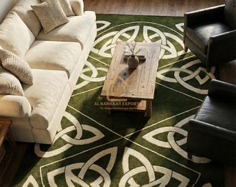 May include: A green rug featuring a white Celtic knot pattern, placed in a living room. The room includes a cream sofa, two black leather armchairs, and a wooden coffee table. The rug's design is geometric and symmetrical.