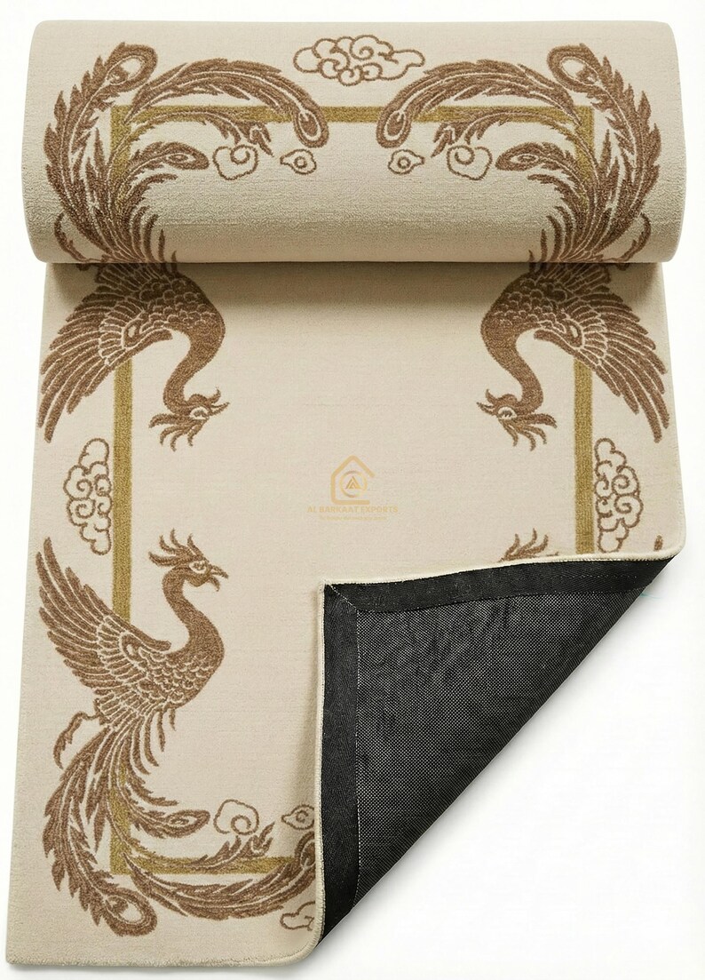 May include: Beige yoga mat featuring a brown phoenix design. The phoenix is framed by a gold border with cloud accents. The mat is partially rolled, revealing a black underside.