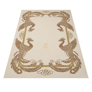 May include: Beige rectangular rug with a brown phoenix design at each corner, framed by a gold border and cloud motifs. The rug has a central beige area and is suitable for home decor.